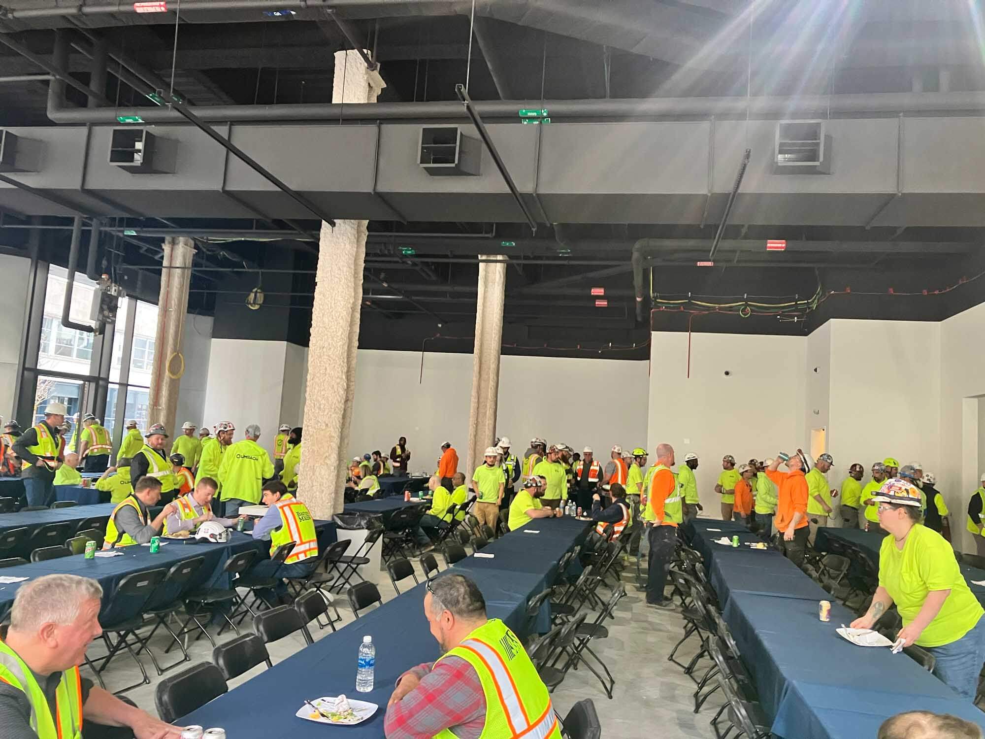 workers enjoy a community meal to celebrate topping off at hudsons detroit